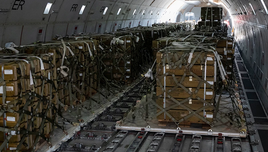 Pallets of ammunition bound for Ukraine are secured inside a commercial plane during a security assistance mission at Dover Air Force Base, Del.