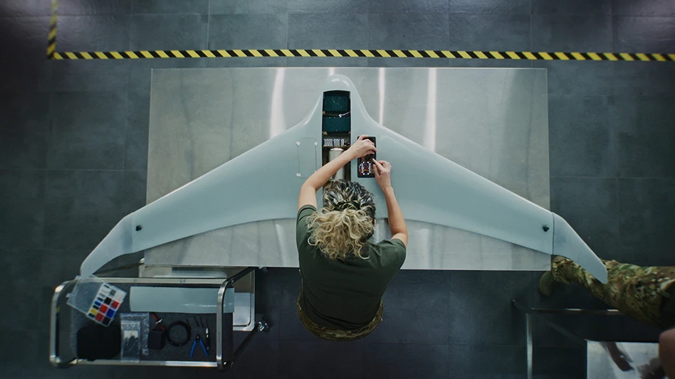 Woman in Camouflage Uniform Working on Next Generation Drone. Female Soldier Installing Electronic Parts Into Surveillance Drone. Concept of Advanced Military Research and Development.